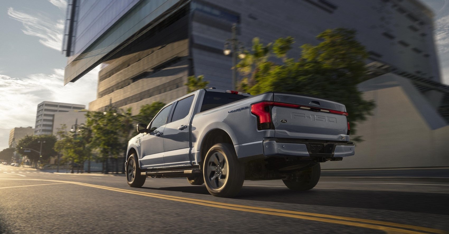 Close up of the back of a Ford F-150 driving down a city road