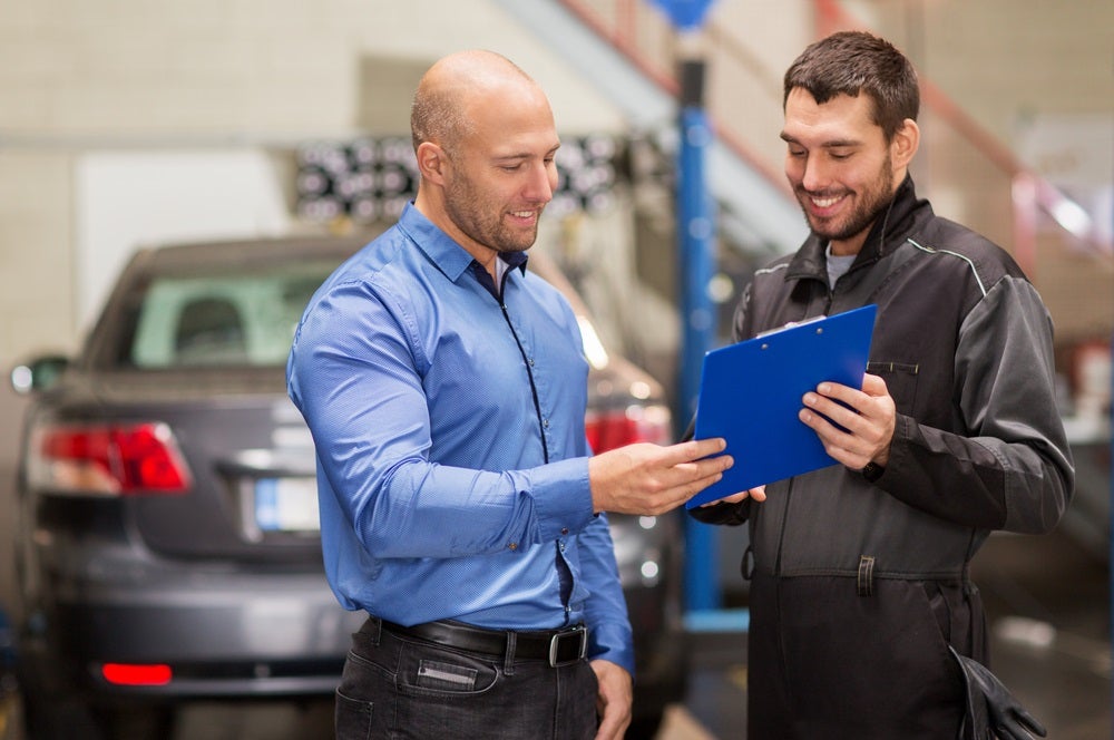 Ford Certified Technician discussing services with Ford customer