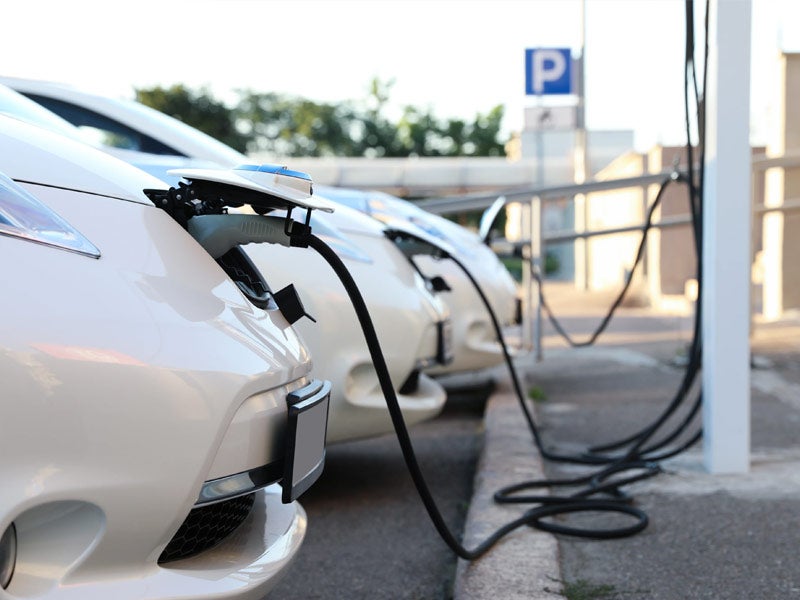 Row of electric vehicles charging at electric dealership in Kingsland GA